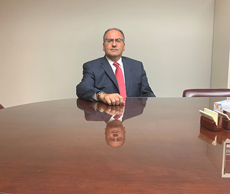 Workers’ Compensation Attorney Joe Nappa sitting at a conference table