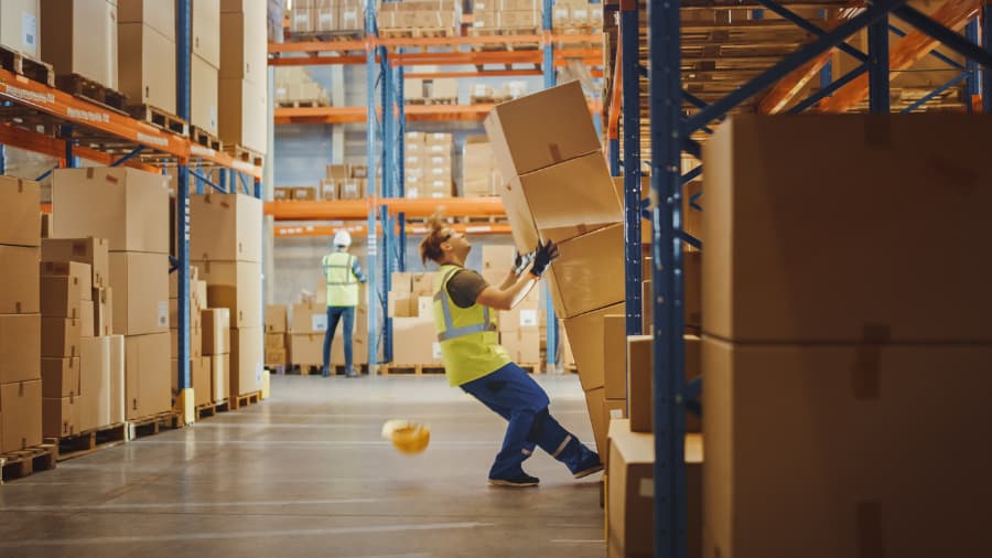 Boxes falling on warehouse worker
