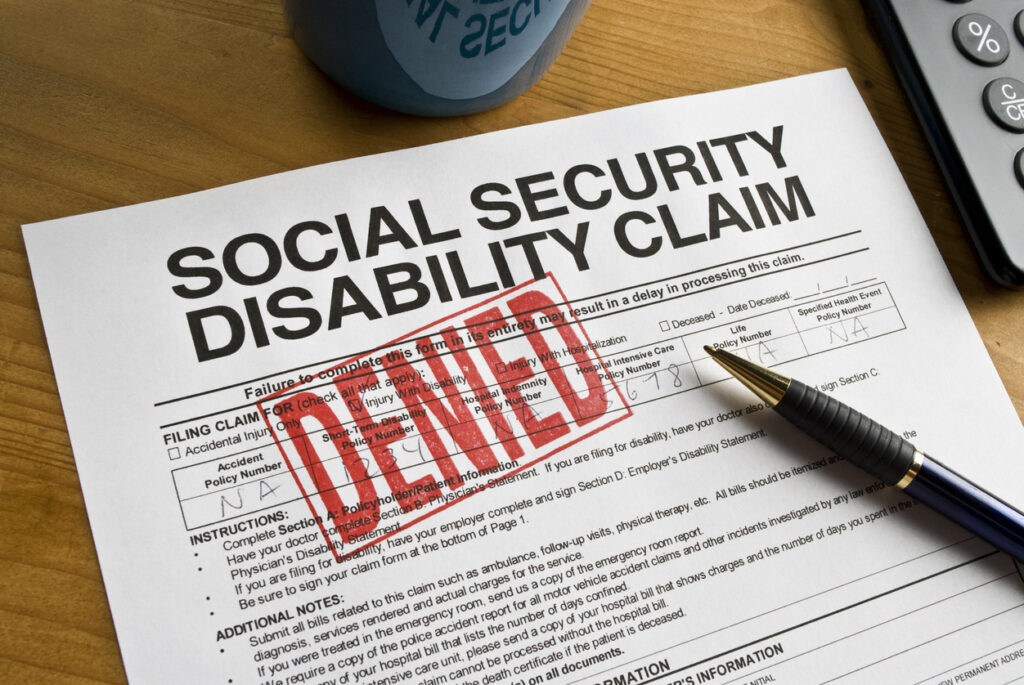 Close-up of a Social Security Disability claim with a red “denied” stamp